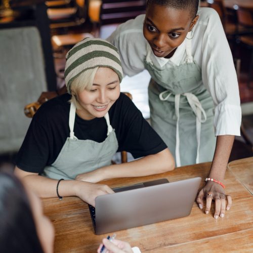 positive-multiethnic-female-colleagues-discussing-business-4349784